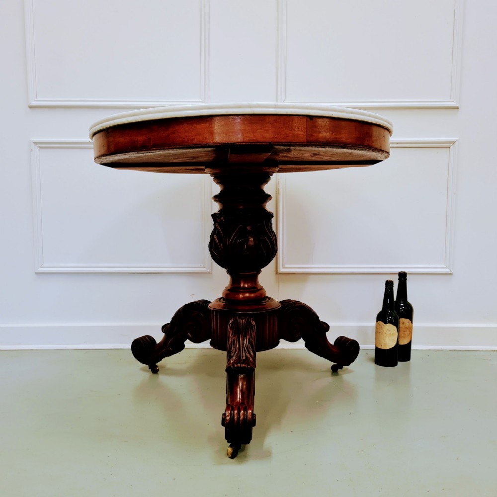A 19th-century French gueridon table featuring a circular white marble top supported by a carved dark mahogany pedestal and scrolled tripod base. View VII