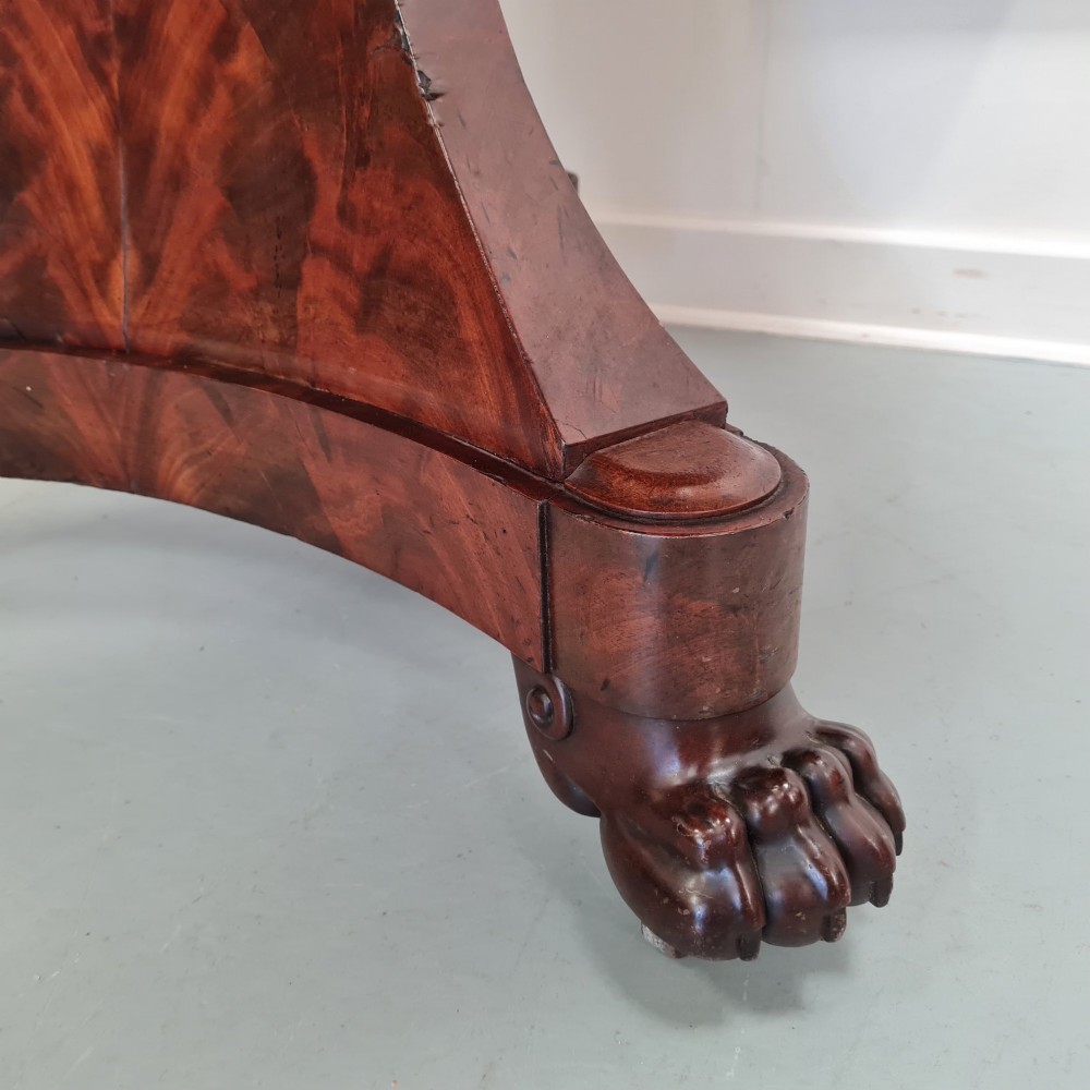 A 19th-century French gueridon featuring a circular dark grey marble top set upon a flame mahogany pedestal with a triform base and carved paw feet. View III
