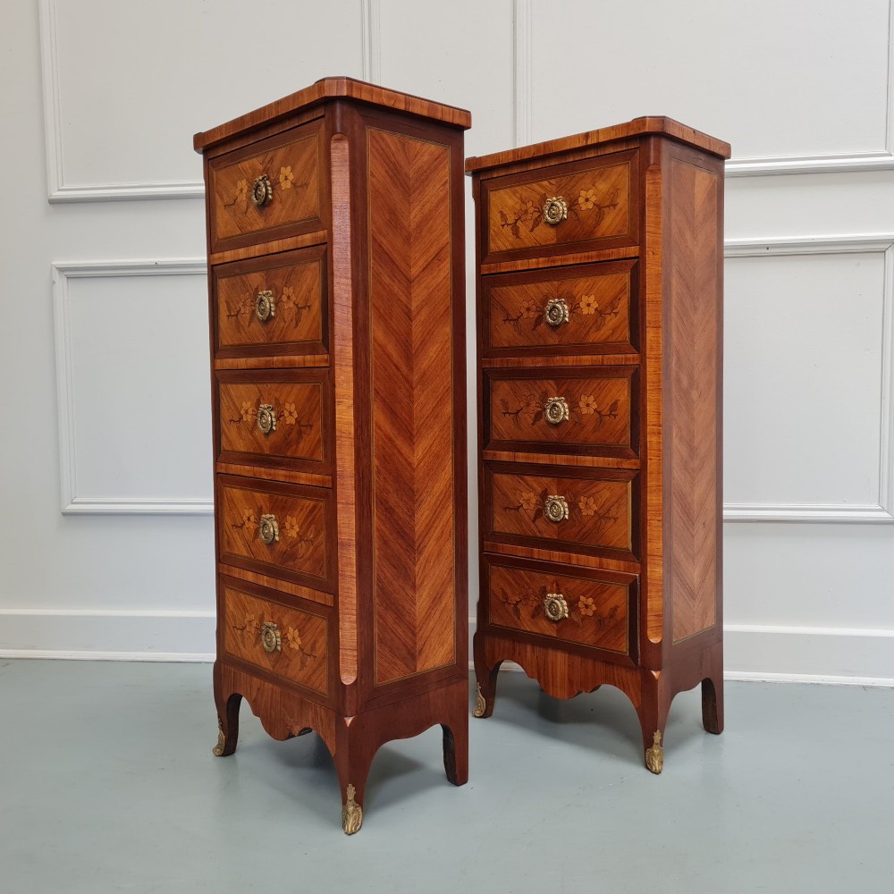 A pair of tall French-style wooden bedside cabinets with floral marquetry inlay, five drawers each, brass rosette handles, and curved cabriole legs with brass feet. View II