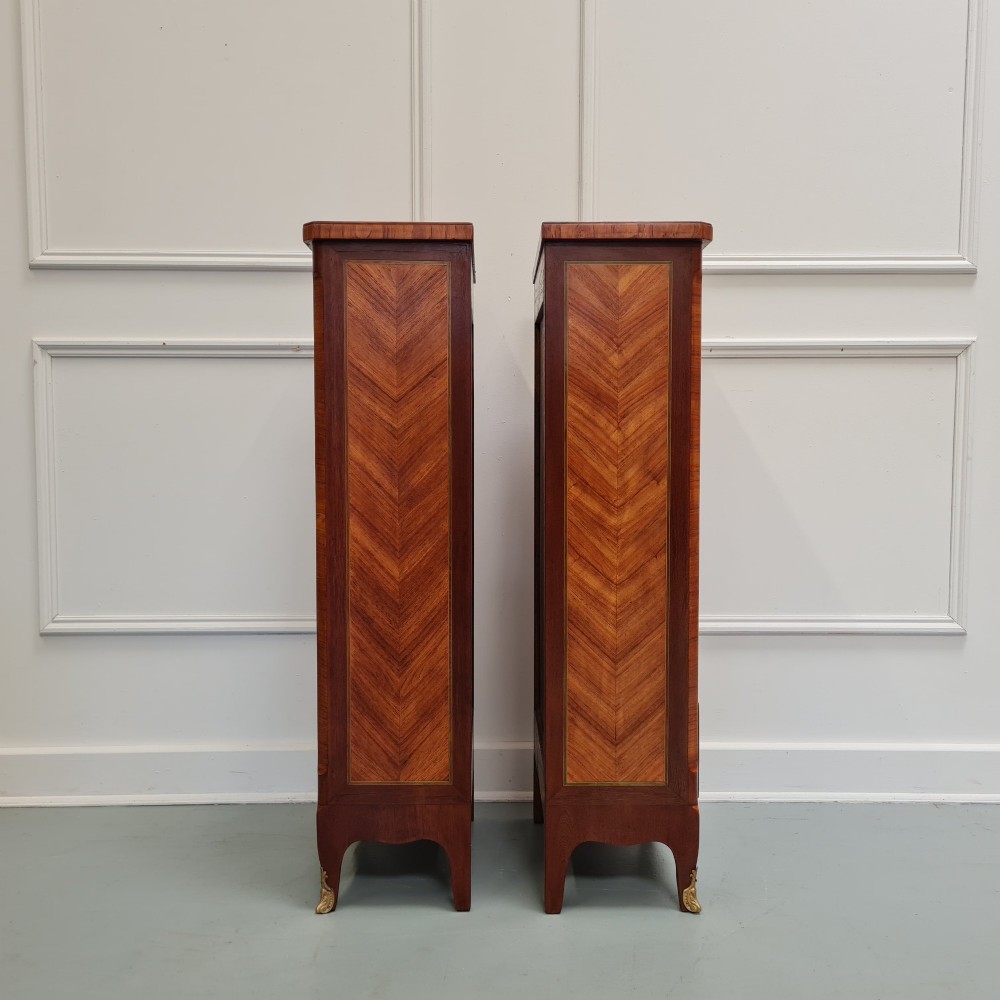 A pair of tall French-style wooden bedside cabinets with floral marquetry inlay, five drawers each, brass rosette handles, and curved cabriole legs with brass feet. View IV