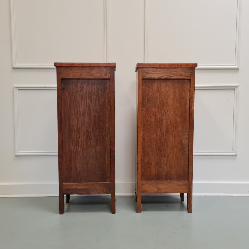 A pair of tall French-style wooden bedside cabinets with floral marquetry inlay, five drawers each, brass rosette handles, and curved cabriole legs with brass feet. View V