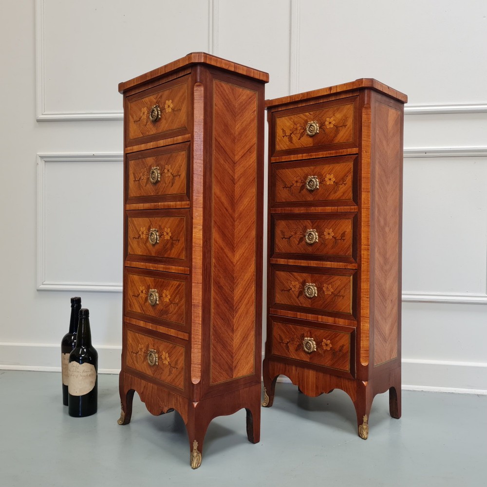 A pair of tall French-style wooden bedside cabinets with floral marquetry inlay, five drawers each, brass rosette handles, and curved cabriole legs with brass feet. View VII