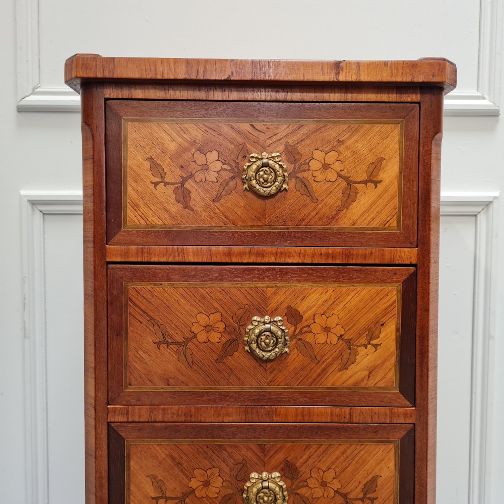 A pair of tall French-style wooden bedside cabinets with floral marquetry inlay, five drawers each, brass rosette handles, and curved cabriole legs with brass feet. View VIII