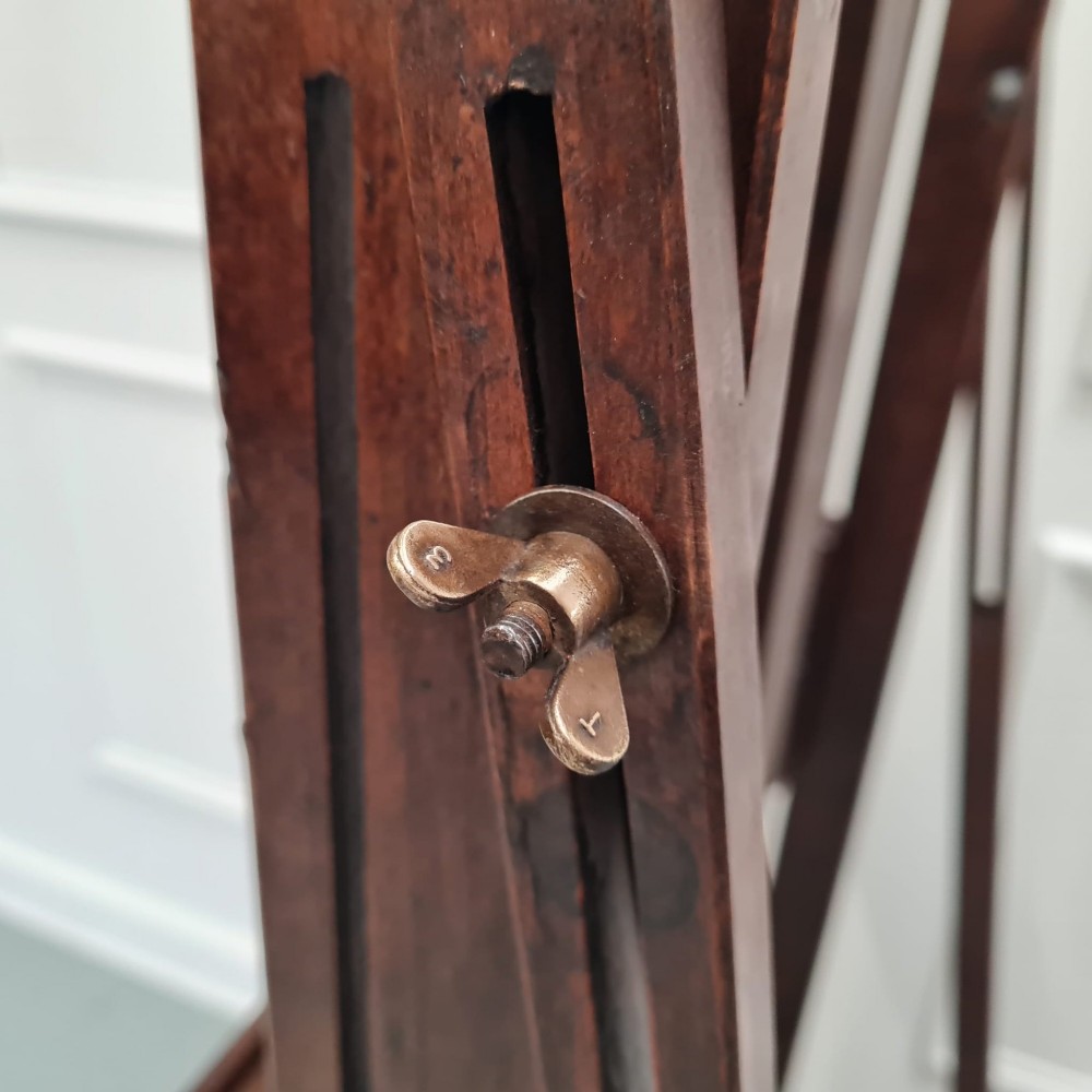 A dark brown French oak H-frame studio easel featuring an adjustable canvas shelf and metal side fixtures. View IX