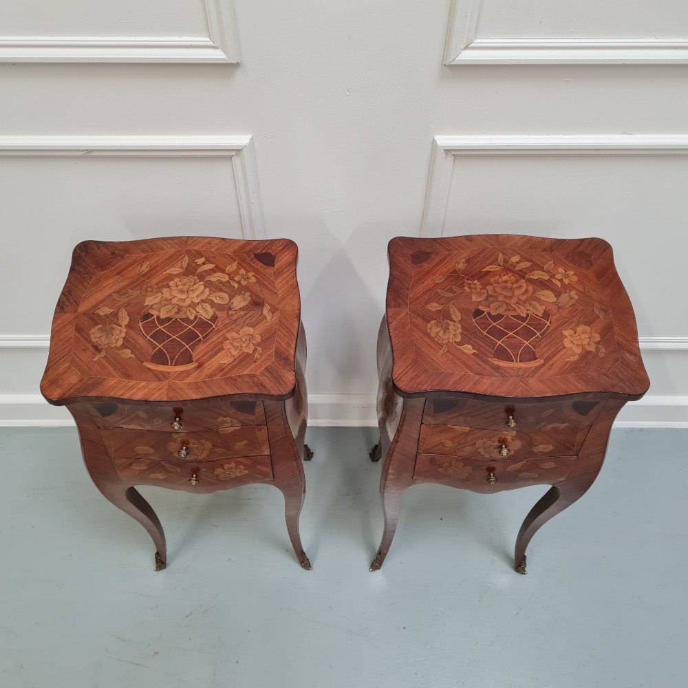 Pair of slender French Kingwood bedside tables with floral marquetry drawers and cabriole legs featuring brass sabots. View II