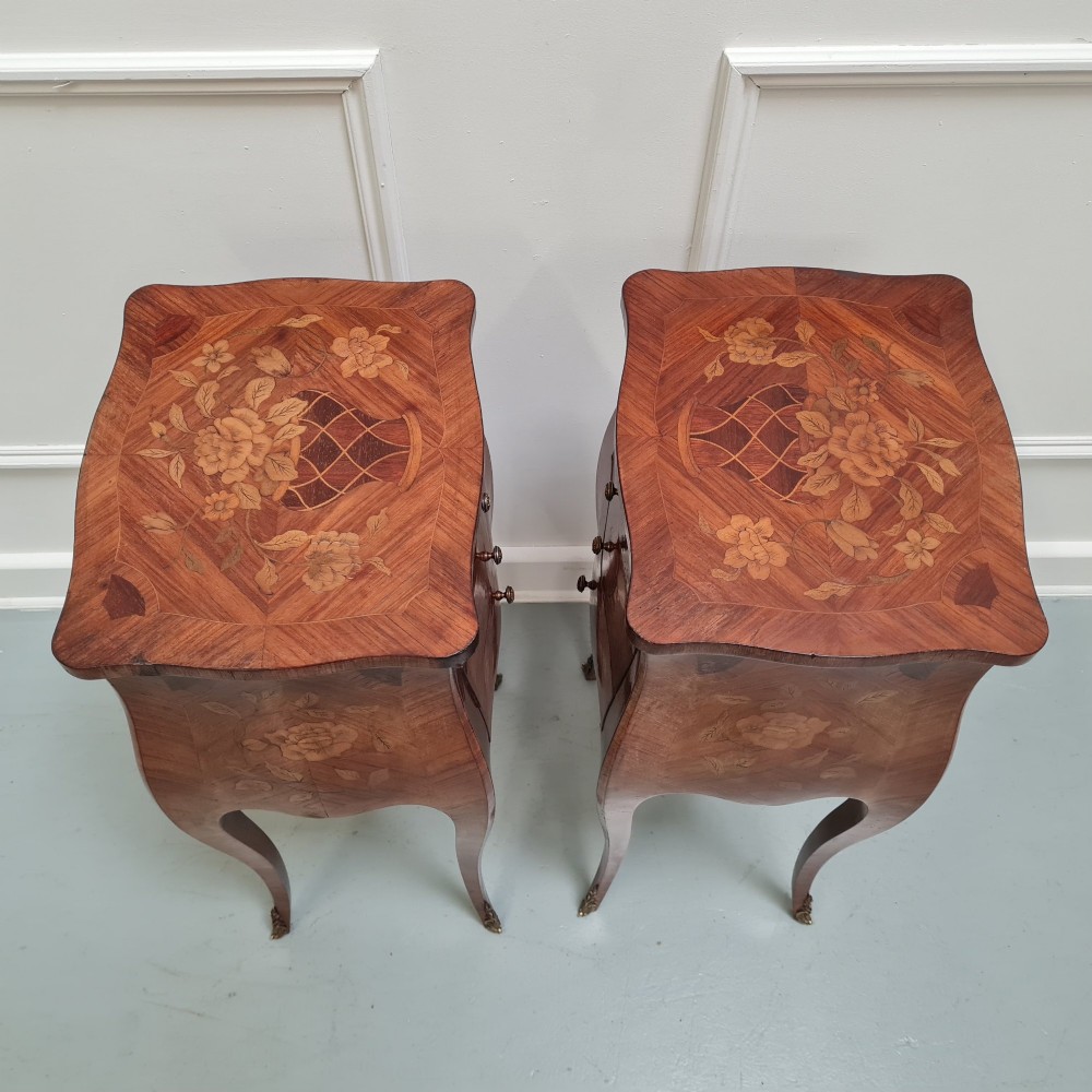 Pair of slender French Kingwood bedside tables with floral marquetry drawers and cabriole legs featuring brass sabots. View V