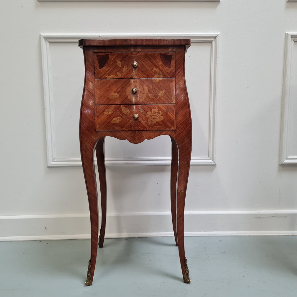 Pair of slender French Kingwood bedside tables with floral marquetry drawers and cabriole legs featuring brass sabots. View X