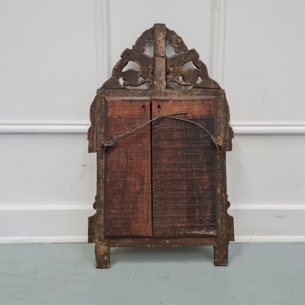A small 18th-century style French giltwood mirror featuring carved cresting with floral rosettes and a fleur-de-lis motif. View IV