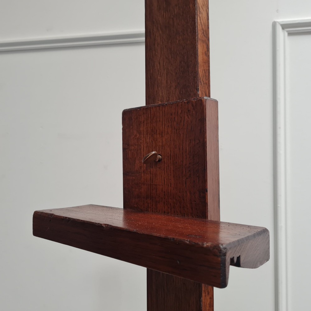 An antique dark oak studio winder easel featuring a mechanical hand crank handle and a floor base equipped with castors. View III