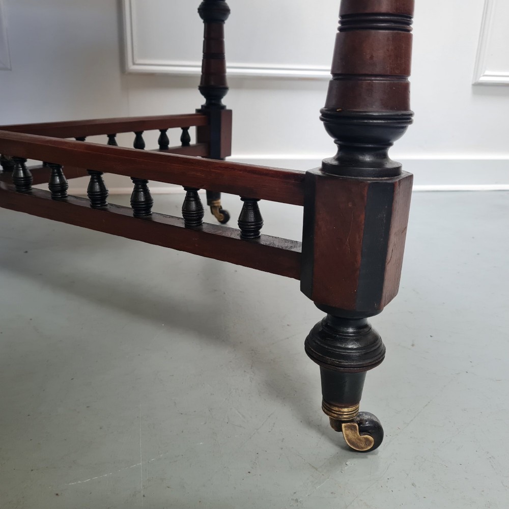An octagonal Victorian Aesthetic Movement centre table featuring a light wood veneered top with ebonised borders, turned legs, and cross-stretchers with turned spindles. View IV