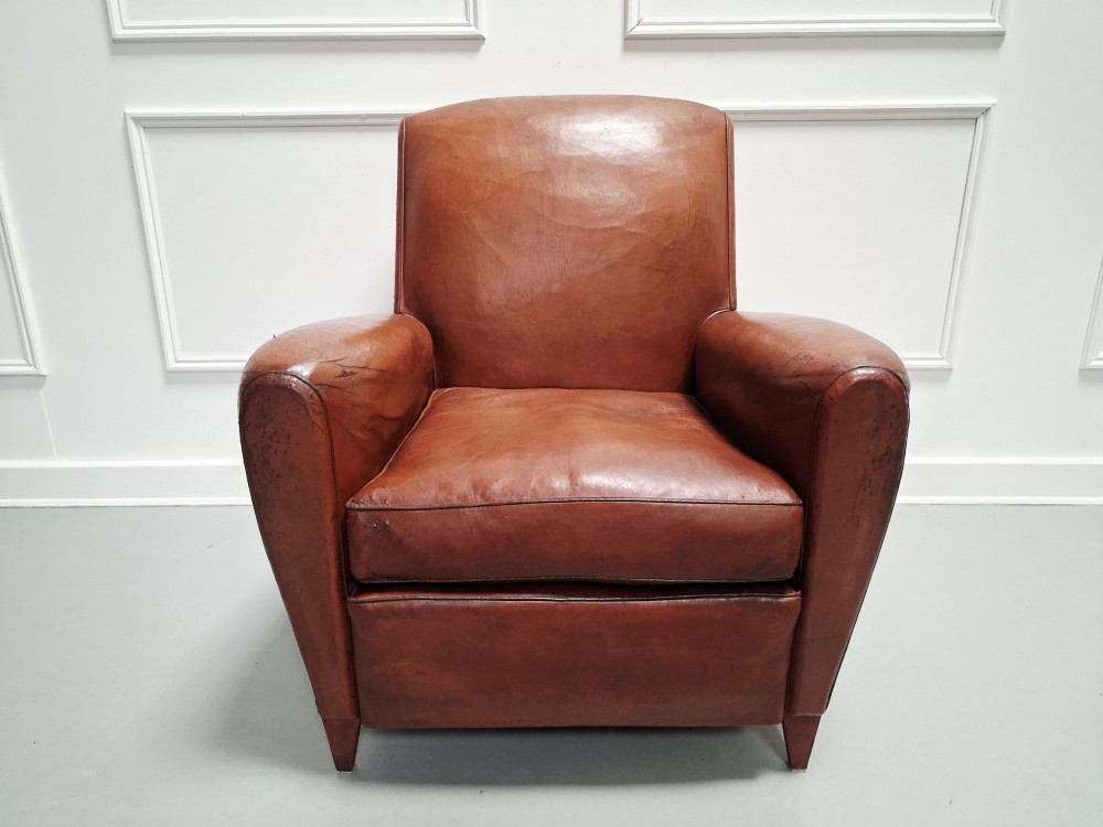 A 1930s French leather club chair upholstered in warm cognac brown patinated leather with rounded armrests and short square feet. View II