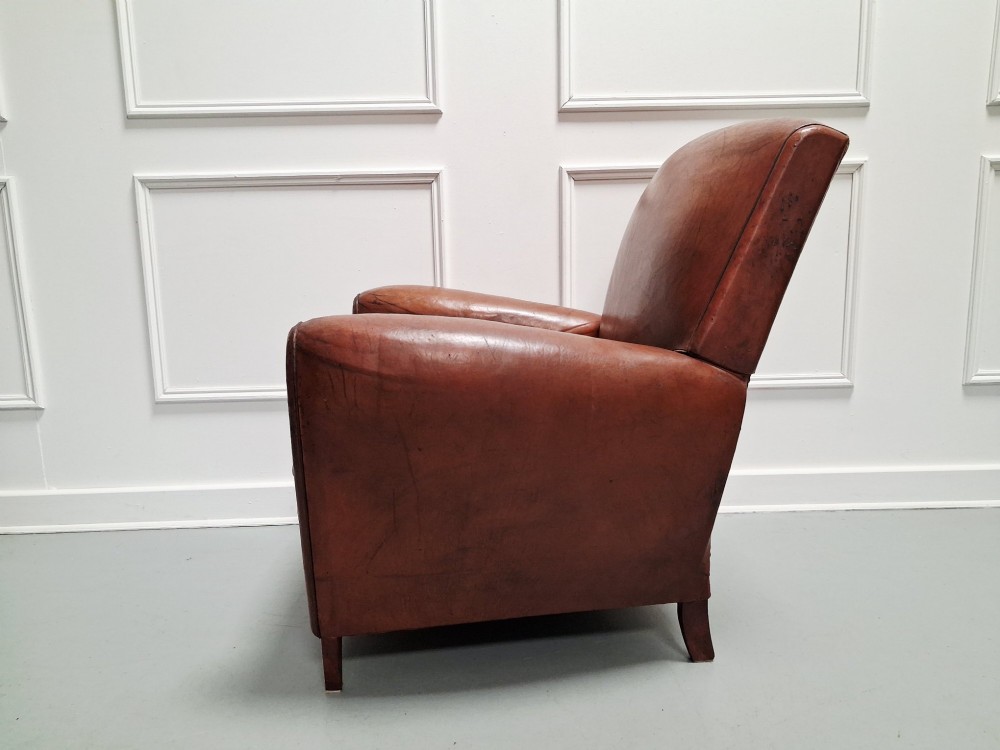 A 1930s French leather club chair upholstered in warm cognac brown patinated leather with rounded armrests and short square feet. View III