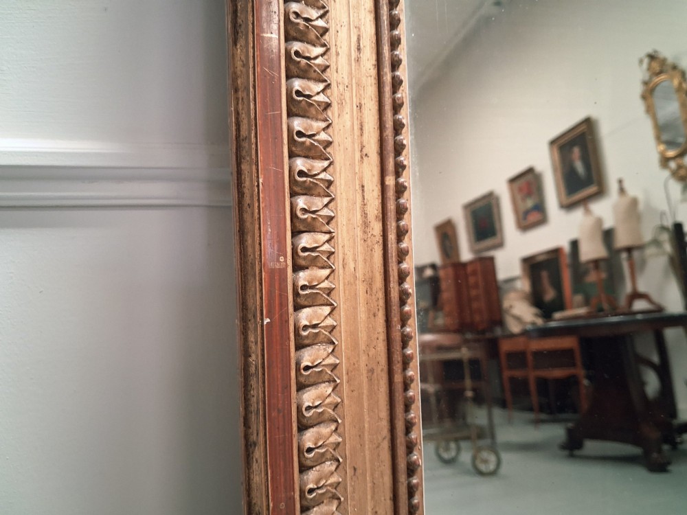 Large 19th-century French giltwood mirror with a carved crest pediment and beaded inner frame. View II