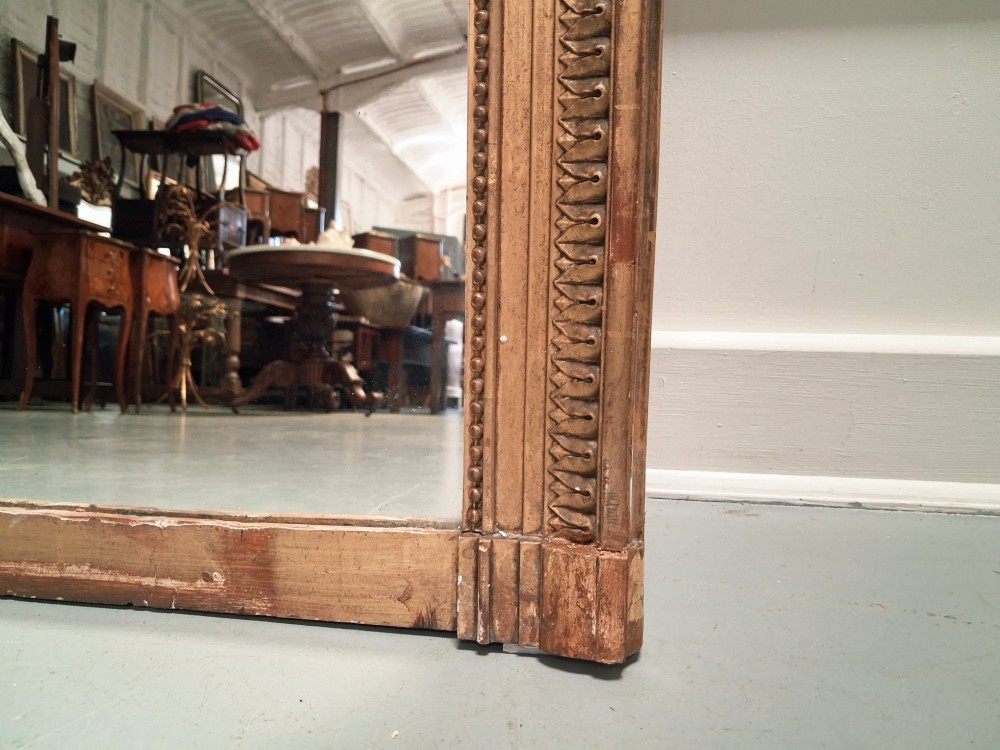 Large 19th-century French giltwood mirror with a carved crest pediment and beaded inner frame. View V