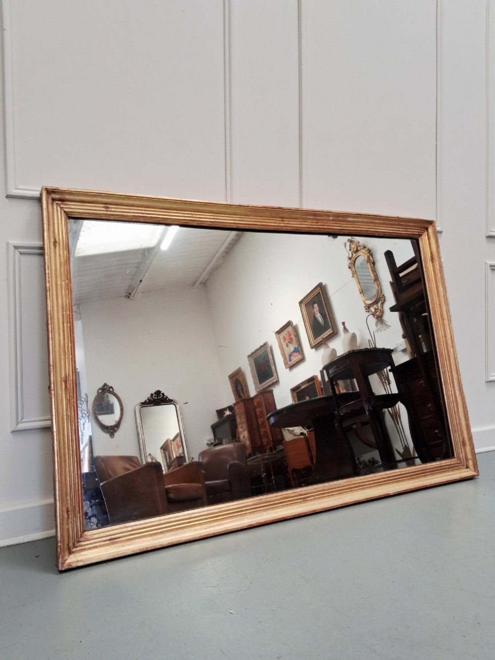 A large rectangular antique mirror featuring a ribbed gilded timber frame with natural age patination. View II