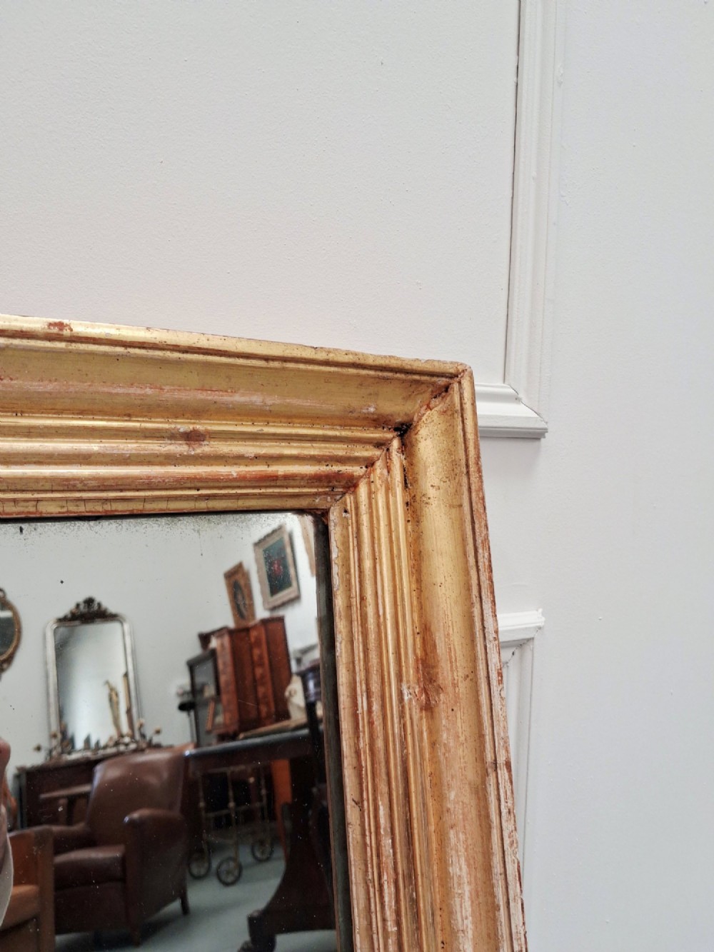 A large rectangular antique mirror featuring a ribbed gilded timber frame with natural age patination. View III