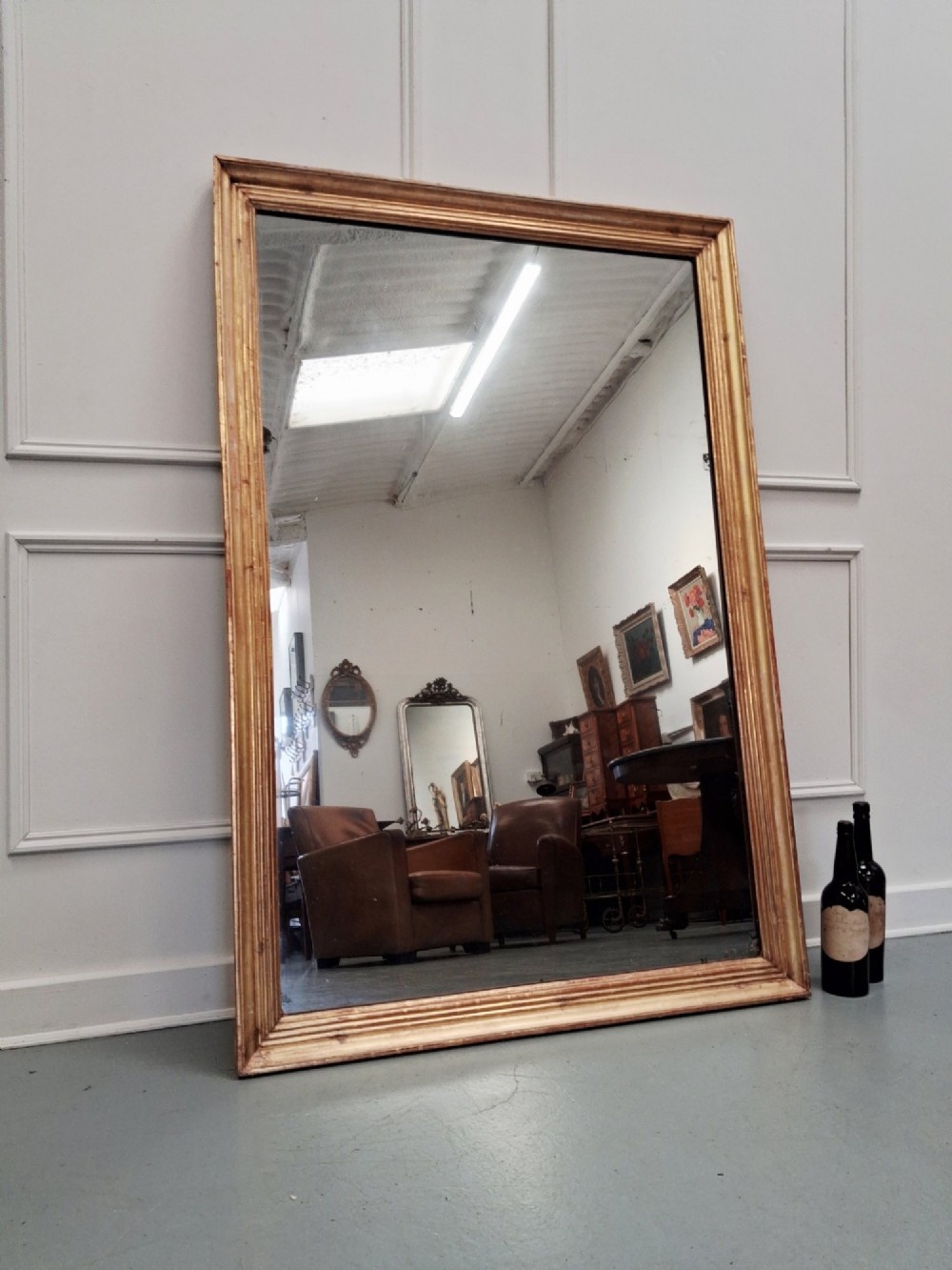 A large rectangular antique mirror featuring a ribbed gilded timber frame with natural age patination. View V