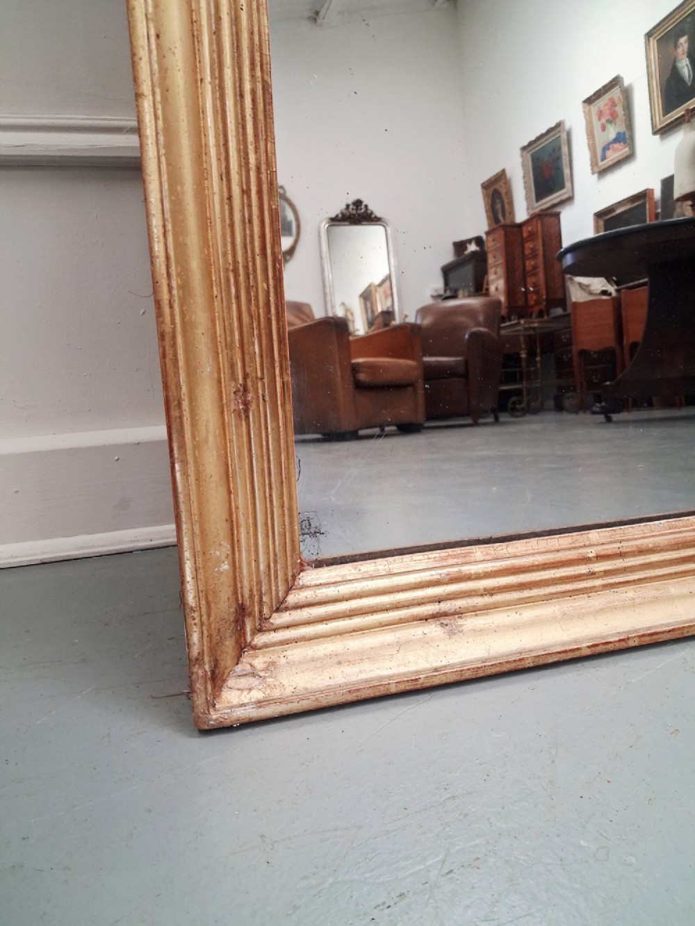 A large rectangular antique mirror featuring a ribbed gilded timber frame with natural age patination. View VI