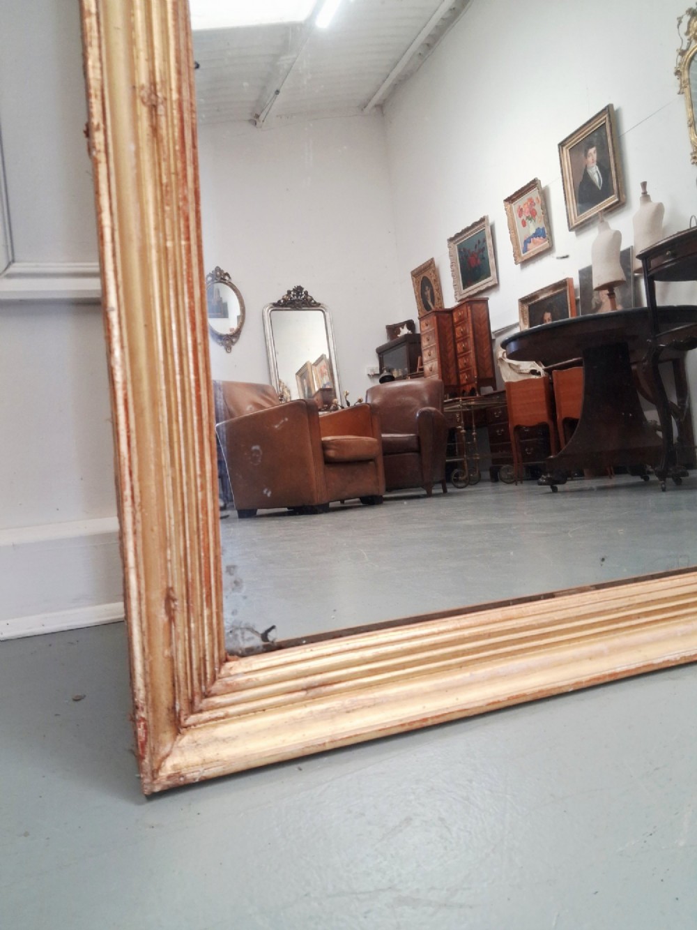 A large rectangular antique mirror featuring a ribbed gilded timber frame with natural age patination. View VIII