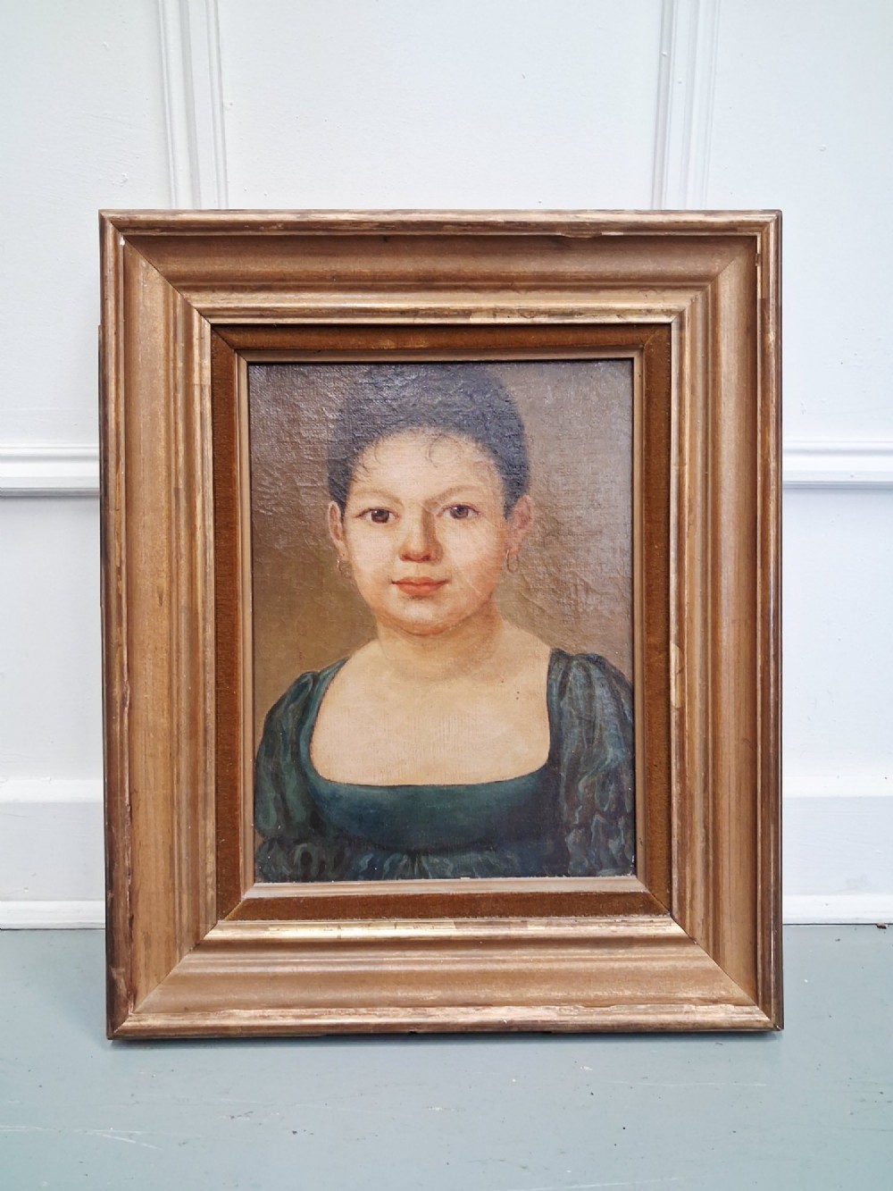 A pair of 19th-century oil portrait paintings depicting a young girl and boy set inside wide moulded giltwood frames. View VI