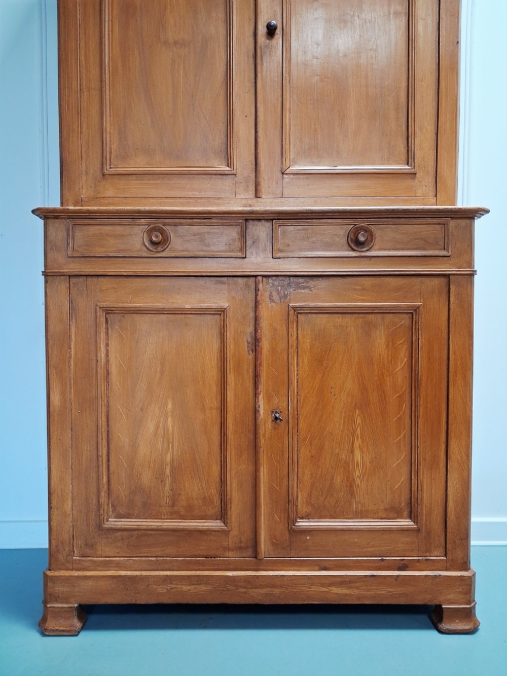 A tall mid-19th century two-tier French provincial housekeepers cupboard with painted ochre timber, panelled cupboard doors, and two central drawers. View III