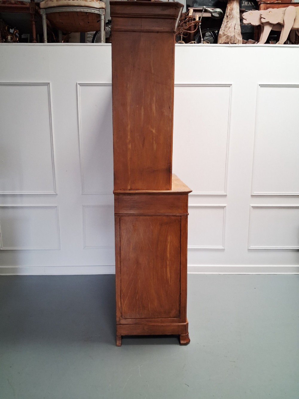 A tall mid-19th century two-tier French provincial housekeepers cupboard with painted ochre timber, panelled cupboard doors, and two central drawers. View VI