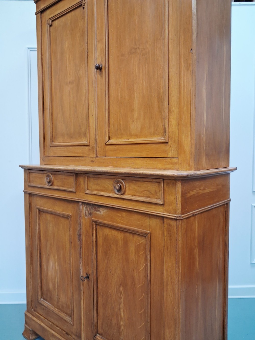 A tall mid-19th century two-tier French provincial housekeepers cupboard with painted ochre timber, panelled cupboard doors, and two central drawers. View X