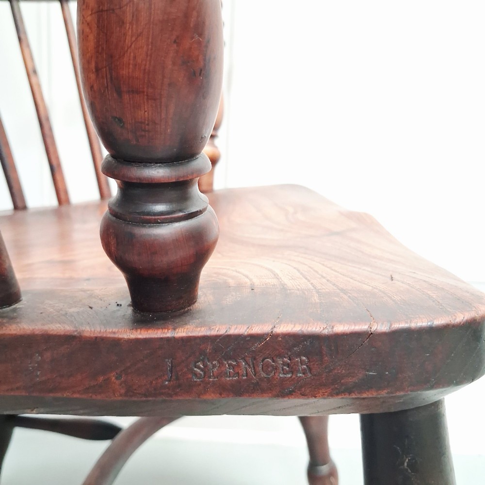 Side view of a mid-19th-century wooden Windsor armchair featuring turned front legs, spindle back, and shaped armrests. View III