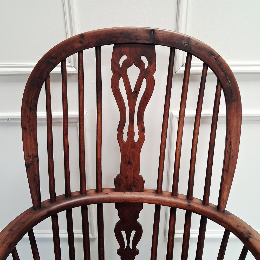 Side view of a mid-19th-century wooden Windsor armchair featuring turned front legs, spindle back, and shaped armrests. View IV