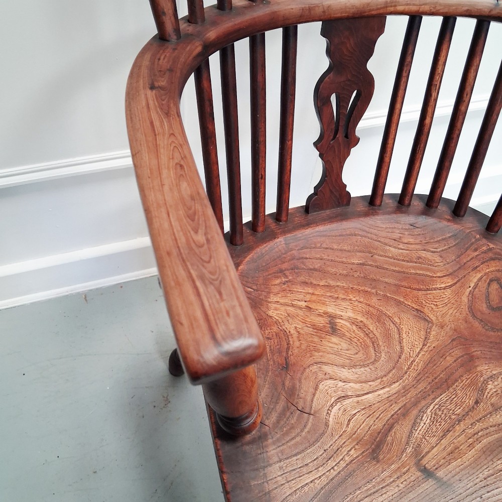 Side view of a mid-19th-century wooden Windsor armchair featuring turned front legs, spindle back, and shaped armrests. View VI