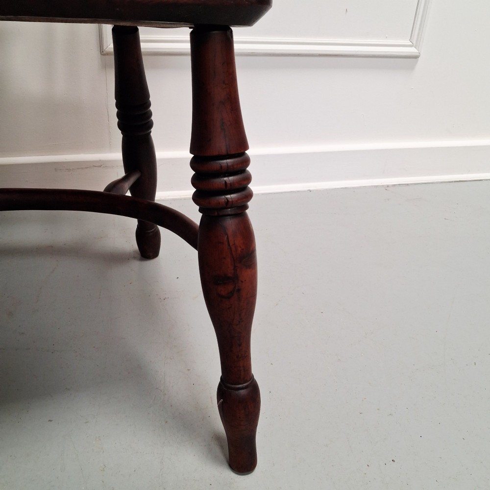 Side view of a mid-19th-century wooden Windsor armchair featuring turned front legs, spindle back, and shaped armrests. View VIII