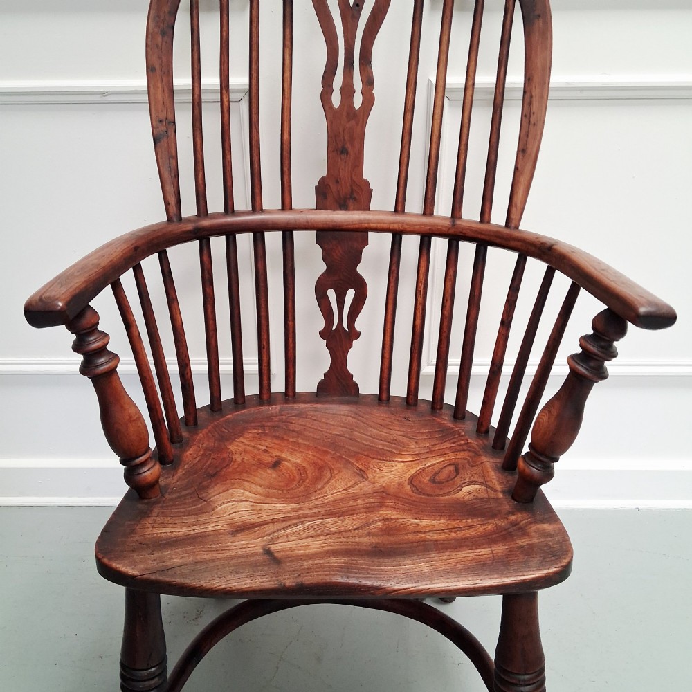 Side view of a mid-19th-century wooden Windsor armchair featuring turned front legs, spindle back, and shaped armrests. View IX