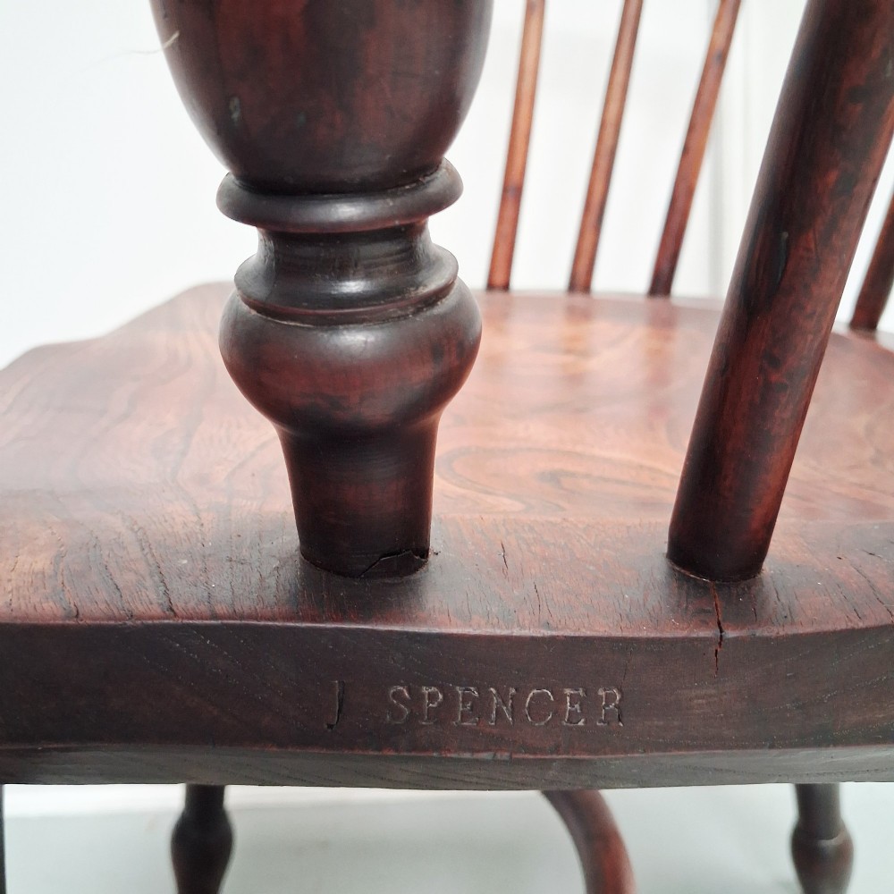 Side view of a mid-19th-century wooden Windsor armchair featuring turned front legs, spindle back, and shaped armrests. View XI