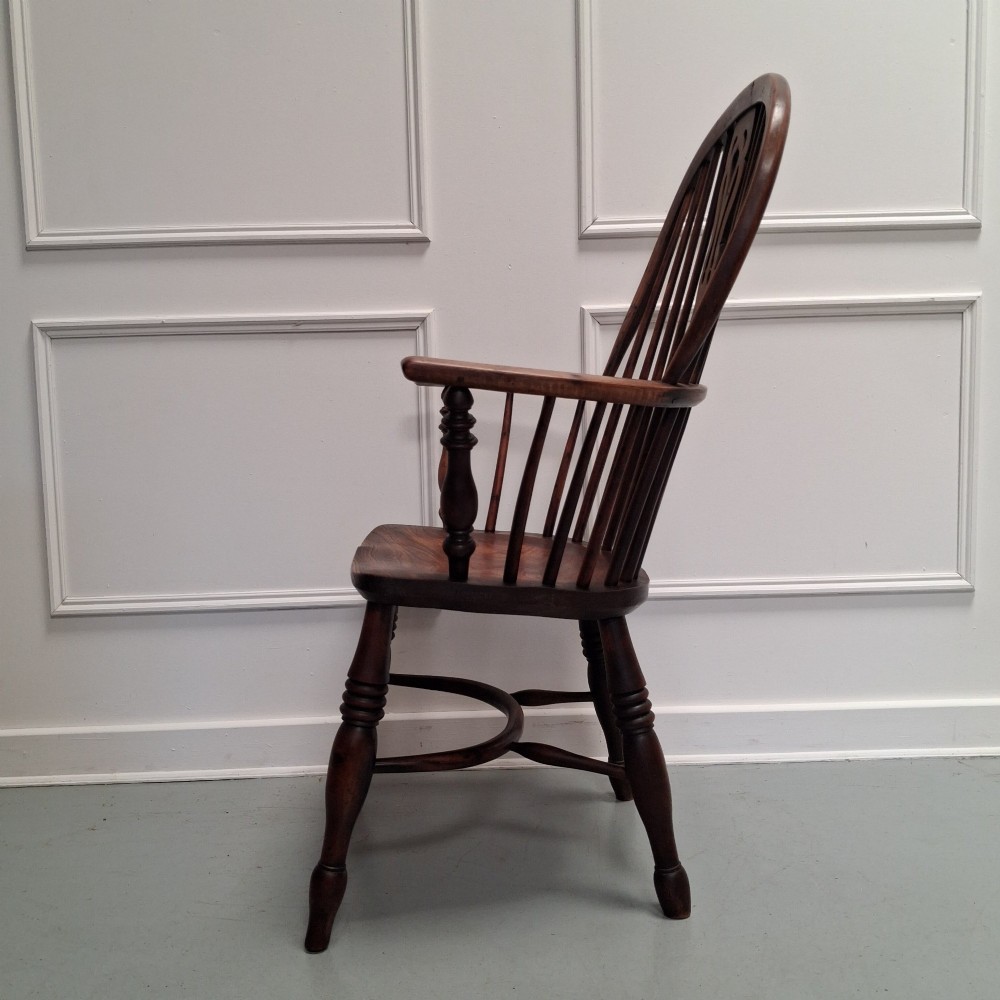 Side view of a mid-19th-century wooden Windsor armchair featuring turned front legs, spindle back, and shaped armrests. View XII
