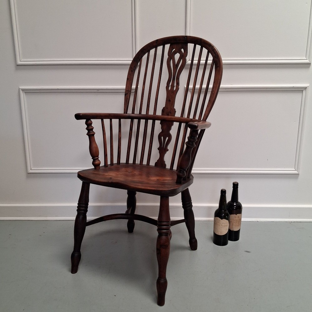 Side view of a mid-19th-century wooden Windsor armchair featuring turned front legs, spindle back, and shaped armrests. View XIII