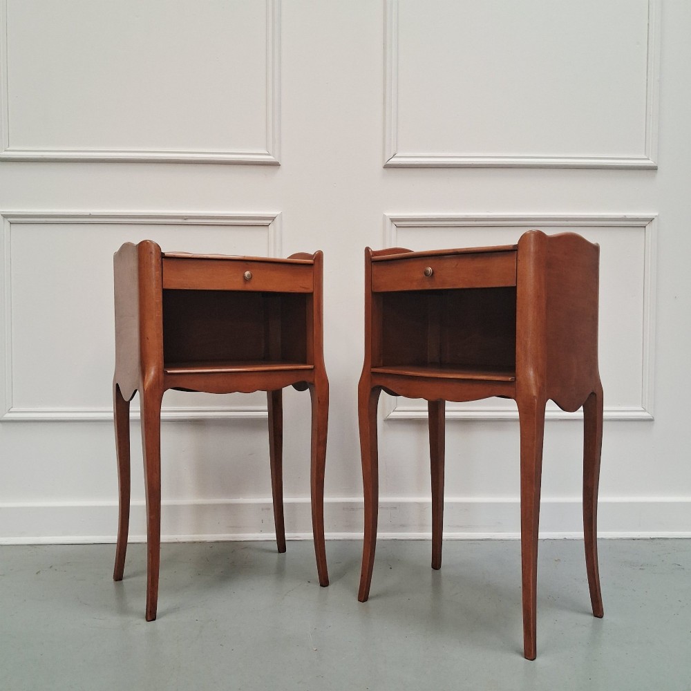 A pair of warm brown French bedside tables with slender cabriole legs, open shelf alcoves, single top drawers, and small metal knobs. View II