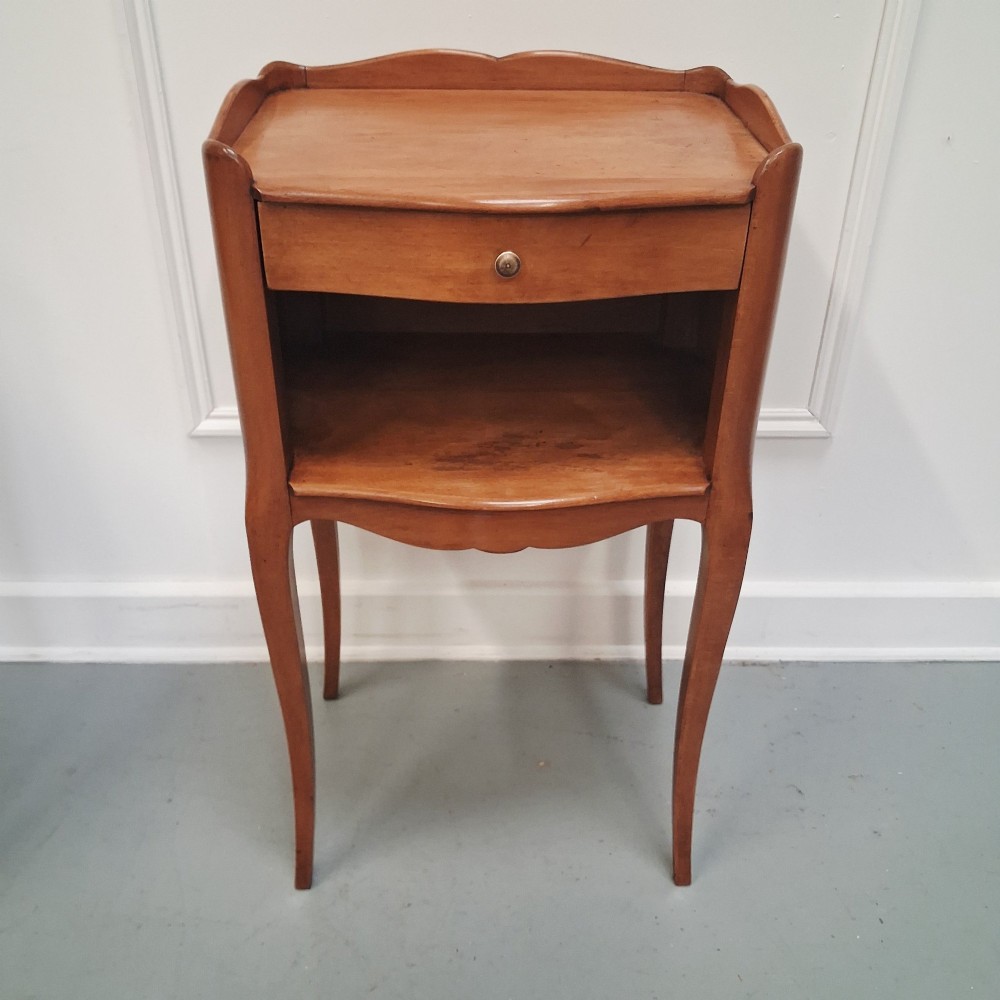 A pair of warm brown French bedside tables with slender cabriole legs, open shelf alcoves, single top drawers, and small metal knobs. View VIII