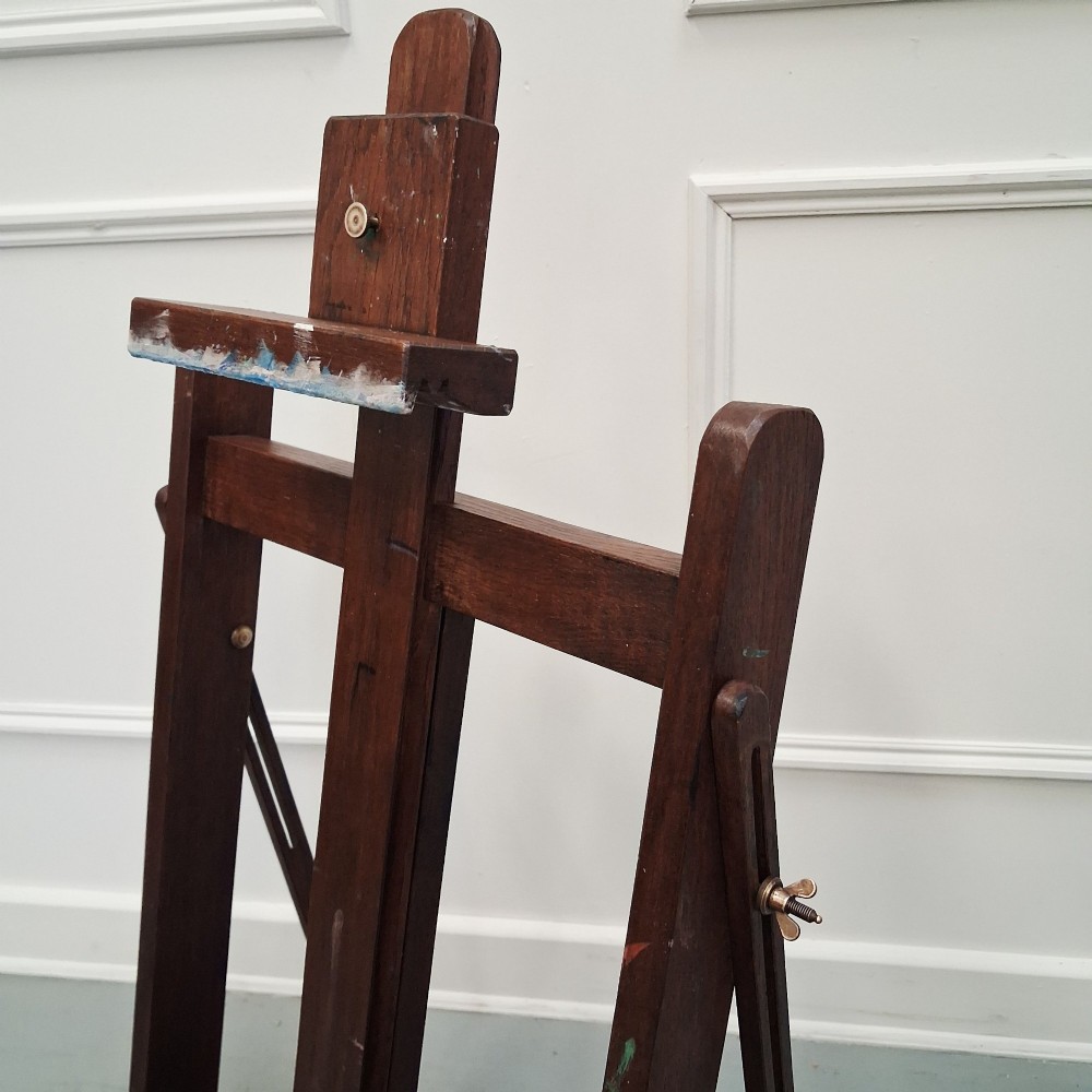 A dark oak French tabletop easel from circa 1930 featuring paint splatter details along the adjustable support ledge and central vertical frame. View III