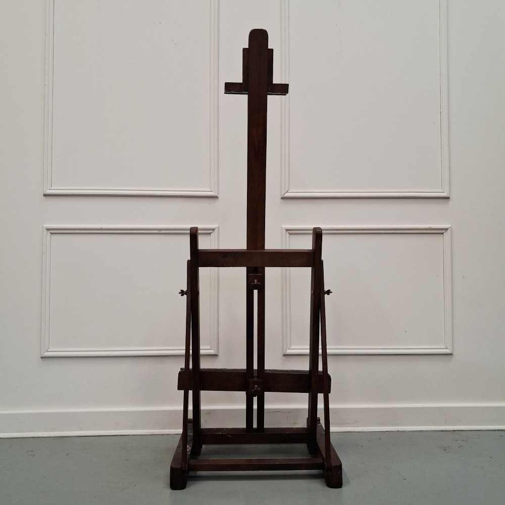 A dark oak French tabletop easel from circa 1930 featuring paint splatter details along the adjustable support ledge and central vertical frame. View VI