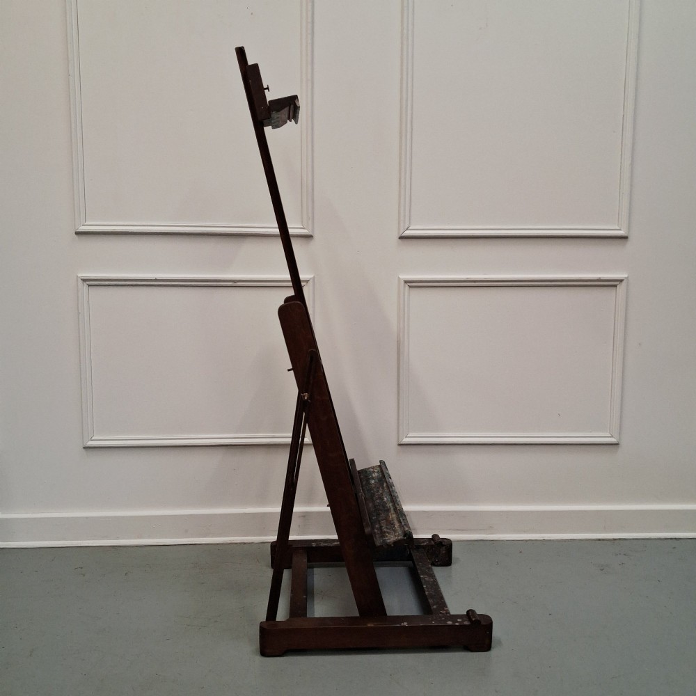 A dark oak French tabletop easel from circa 1930 featuring paint splatter details along the adjustable support ledge and central vertical frame. View VII