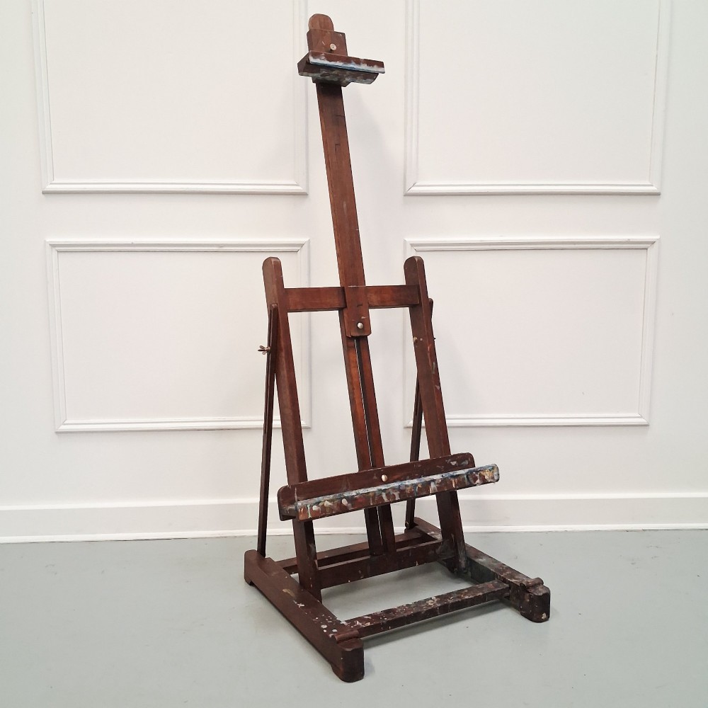 A dark oak French tabletop easel from circa 1930 featuring paint splatter details along the adjustable support ledge and central vertical frame. View VIII
