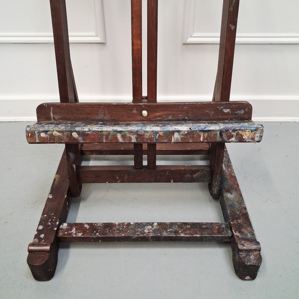 A dark oak French tabletop easel from circa 1930 featuring paint splatter details along the adjustable support ledge and central vertical frame. View IX