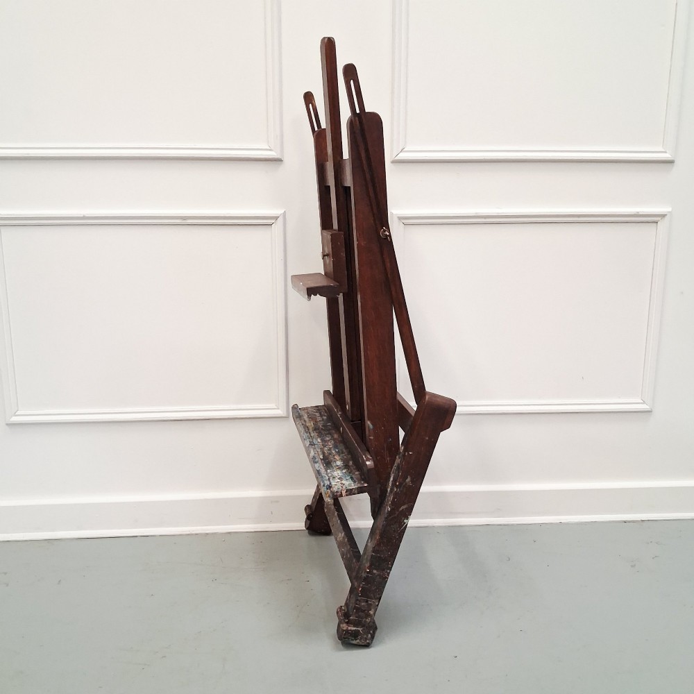 A dark oak French tabletop easel from circa 1930 featuring paint splatter details along the adjustable support ledge and central vertical frame. View XII