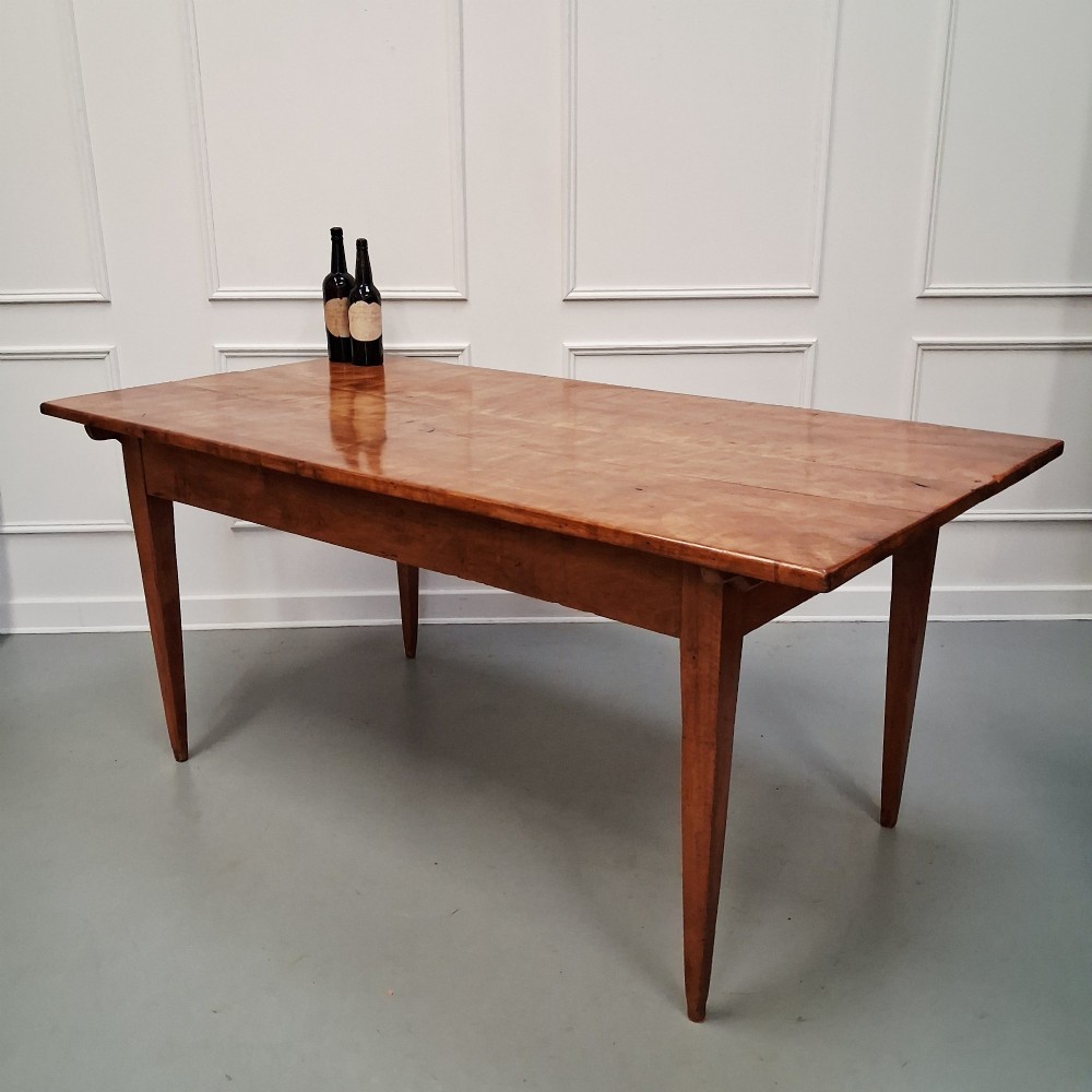 An antique 19th-century satin birch farmhouse table featuring a rectangular plank top, deep apron, and four square tapered legs. View III