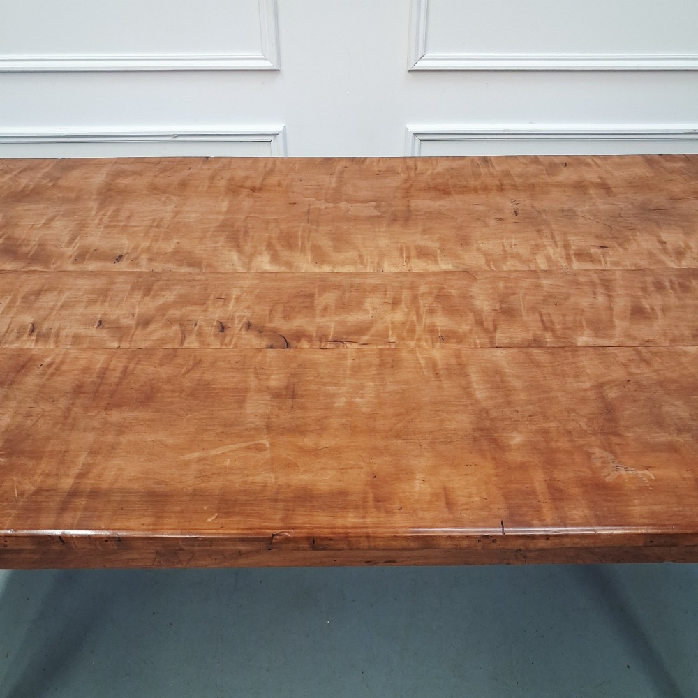 An antique 19th-century satin birch farmhouse table featuring a rectangular plank top, deep apron, and four square tapered legs. View V