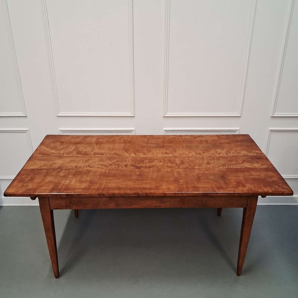 An antique 19th-century satin birch farmhouse table featuring a rectangular plank top, deep apron, and four square tapered legs. View VI