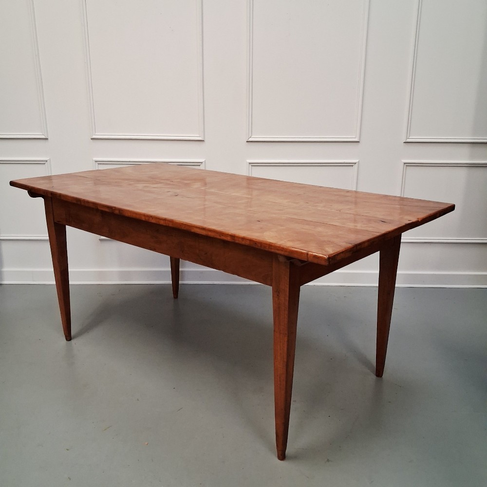 An antique 19th-century satin birch farmhouse table featuring a rectangular plank top, deep apron, and four square tapered legs. View VII