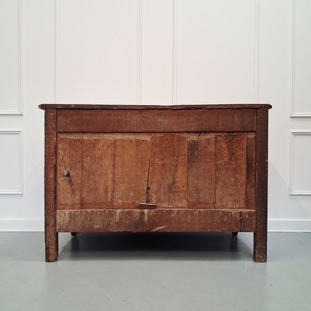 An antique French oak commode featuring two wide drawers with carved moulded panel details, brass drop handles, a scalloped lower apron, and short cabriole feet. View IX