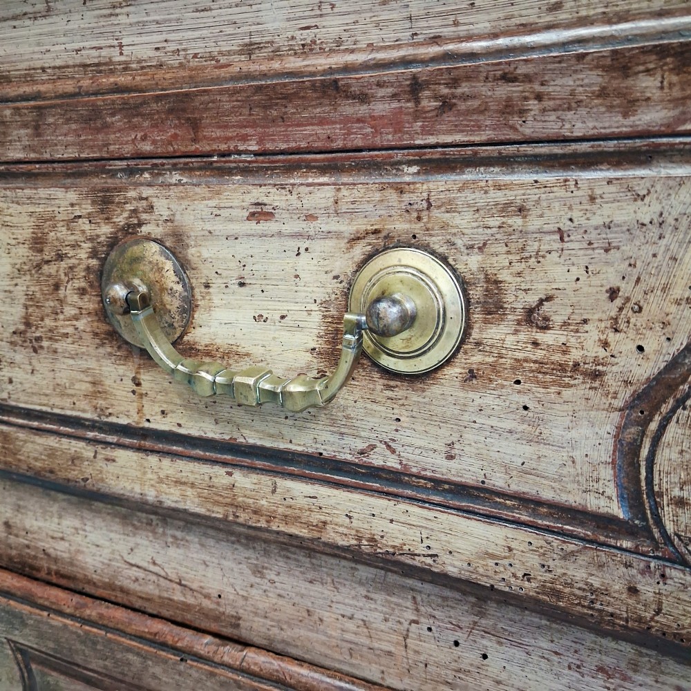 An antique French oak commode featuring two wide drawers with carved moulded panel details, brass drop handles, a scalloped lower apron, and short cabriole feet. View XII