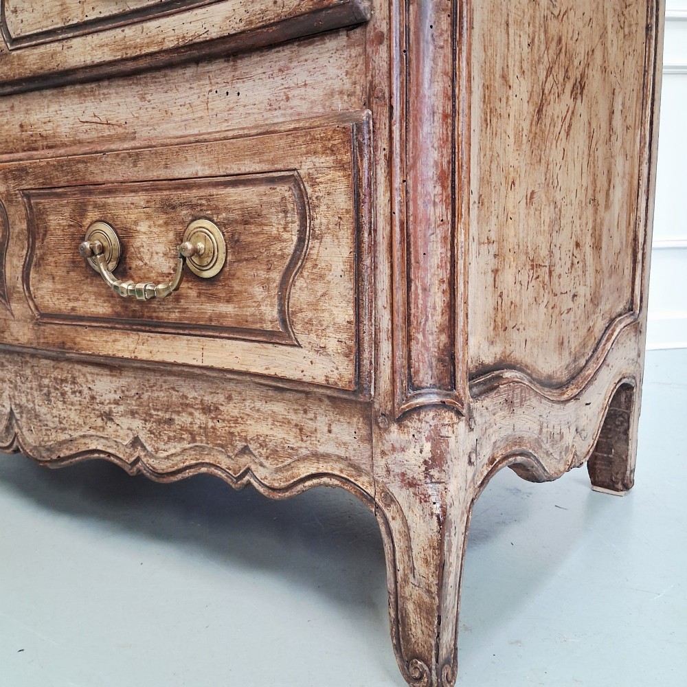 An antique French oak commode featuring two wide drawers with carved moulded panel details, brass drop handles, a scalloped lower apron, and short cabriole feet. View XIII